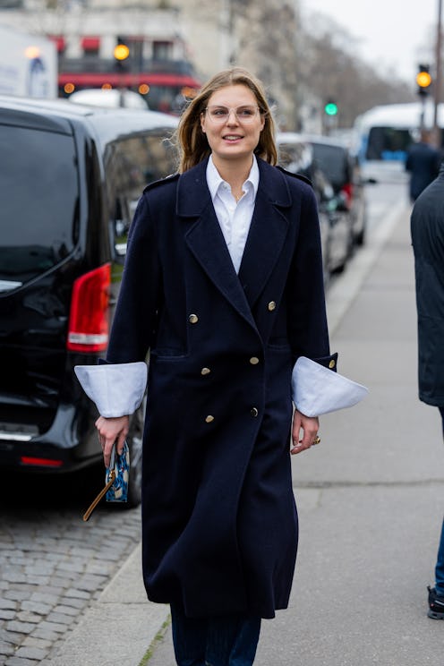 Claire Beermann wears navy double breasted coat, white button shirt outside Stella McCartney during ...