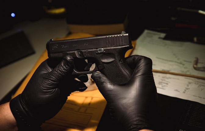 An evidence technician inventories a Glock 9 mm at the Chicago police firearms laboratory at the Hom...