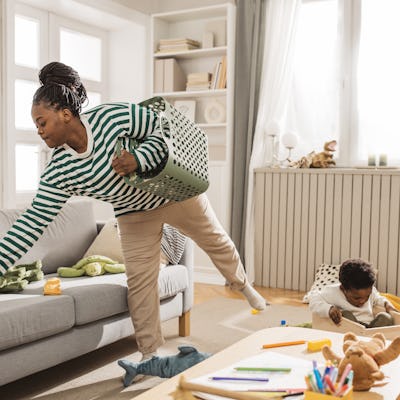 A mother tidies up. Mothers take on 79% of daily household tasks, a larger portion of "invisible labor" than men, according to researchers.