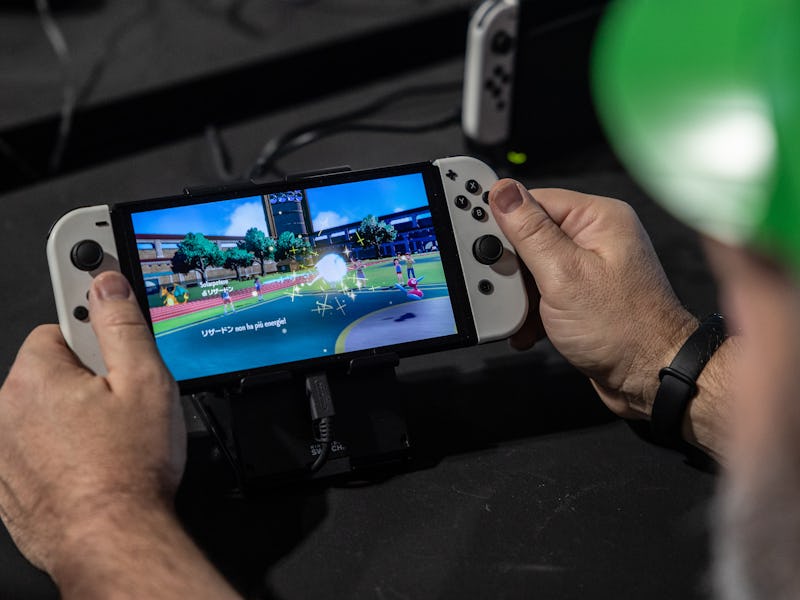 MILAN, ITALY - NOVEMBER 22: A man handles a Nintendo Switch gaming system during Milan Games Week & ...