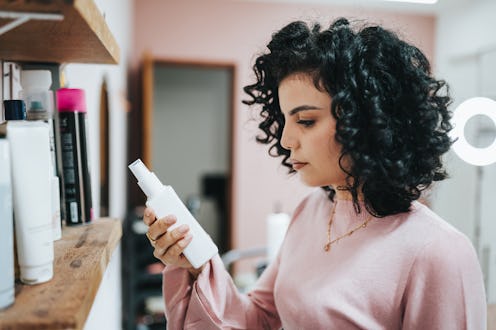 Beautician reading beauty product label