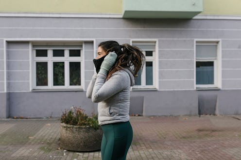 Hispanic woman going for a run on a freezing winter's day.