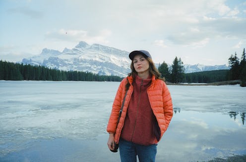 portrait of serene woman standing near the lake in Canada in winter