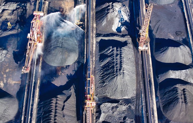 RIZHAO, CHINA - NOVEMBER 22: Aerial view of piles of coal at Rizhao port on November 22, 2024 in Riz...