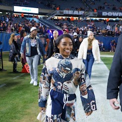 CHICAGO, ILLINOIS - DECEMBER 26: Simone Biles is seen on the sideline prior to an NFL football game …