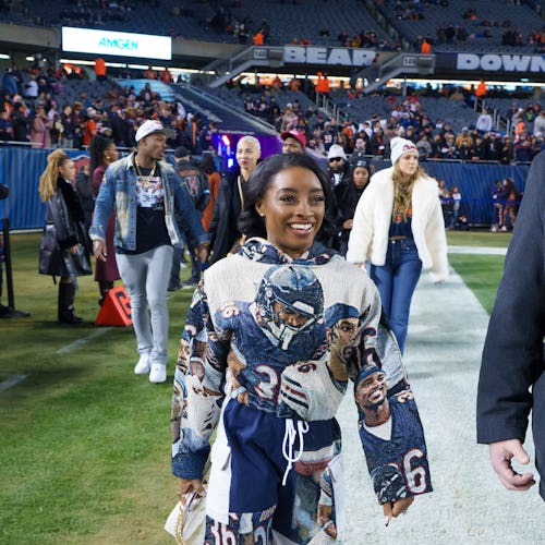 CHICAGO, ILLINOIS - DECEMBER 26: Simone Biles is seen on the sideline prior to an NFL football game …