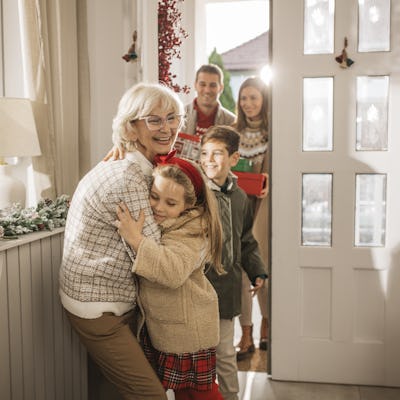 Grandparents welcoming grandchildren and parents for Christmas at home.