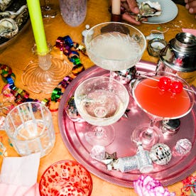 High Angle Still Life Of Cocktails And Champagne Glasses On Tray On Table With Decorations At New Ye...