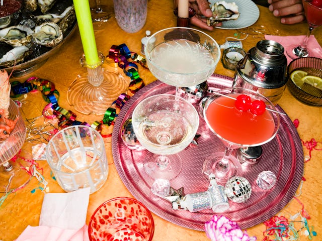 High Angle Still Life Of Cocktails And Champagne Glasses On Tray On Table With Decorations At New Ye...