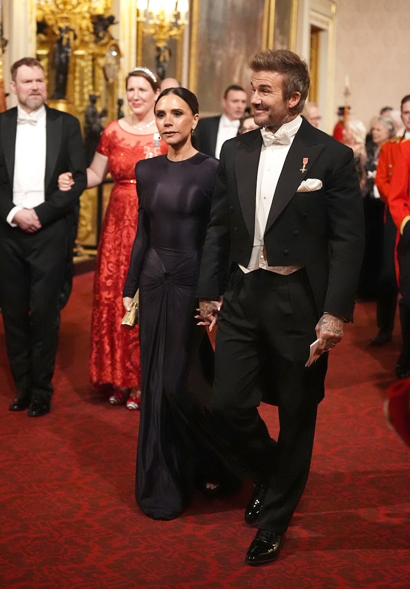 LONDON, ENGLAND - DECEMBER 3: Victoria and David Beckham make their way along the East Gallery to at...