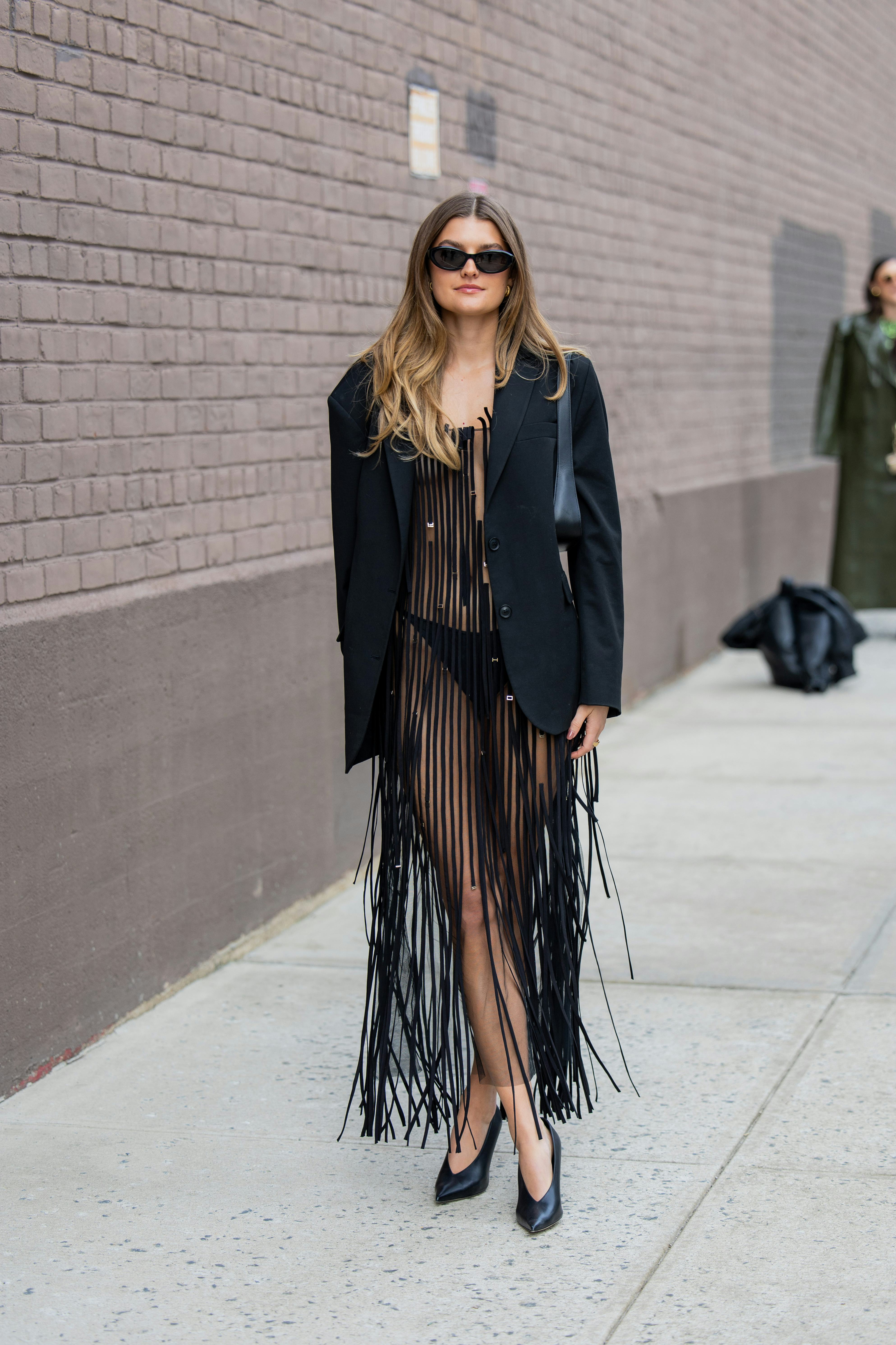 Sara Walker wears black transparent fringed dress, blazer outside Jason Wu on February 11, 2024 in N&hellip;