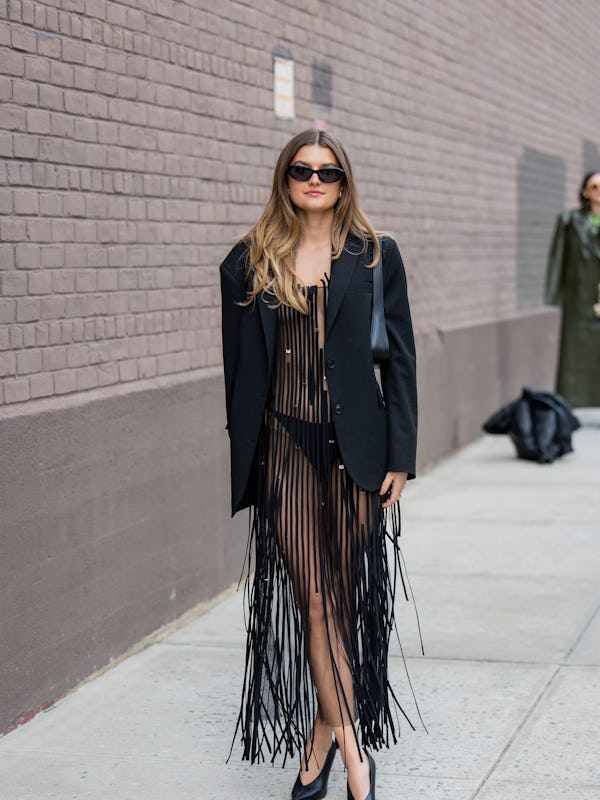Sara Walker wears black transparent fringed dress, blazer outside Jason Wu on February 11, 2024 in N…