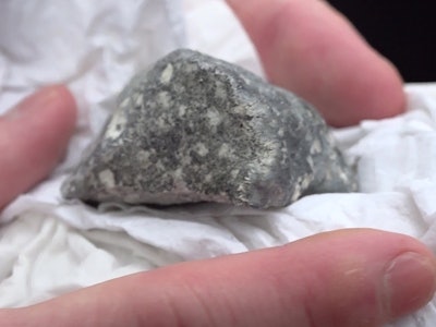 26 January 2024, Brandenburg, Ribbeck: A suspected meteorite fragment lies in a paper handkerchief. ...