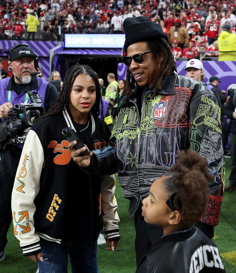 LAS VEGAS, NEVADA - FEBRUARY 11: American Rapper Jay-Z stands on the sidelines with daughter Blue Iv...