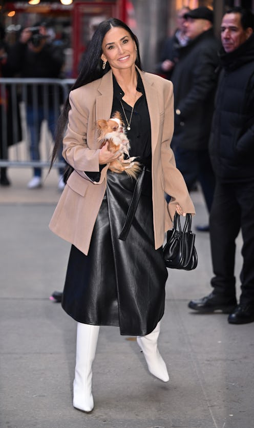 Demi Moore at Carolina Herrera RTW Fall 2024 in a matching plaid dress and cape set