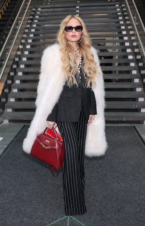 Rachel Zoe at the Carolina Herrera Fall/Winter 2024 runway show in a pinstripe suit set and a fur co...