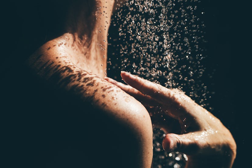 Woman taking a shower close up.
