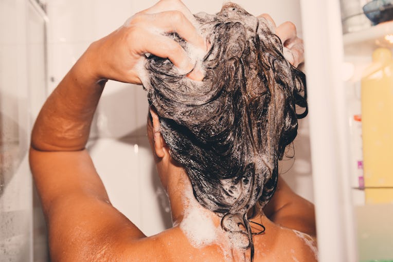 Woman washing her hair in the shower.