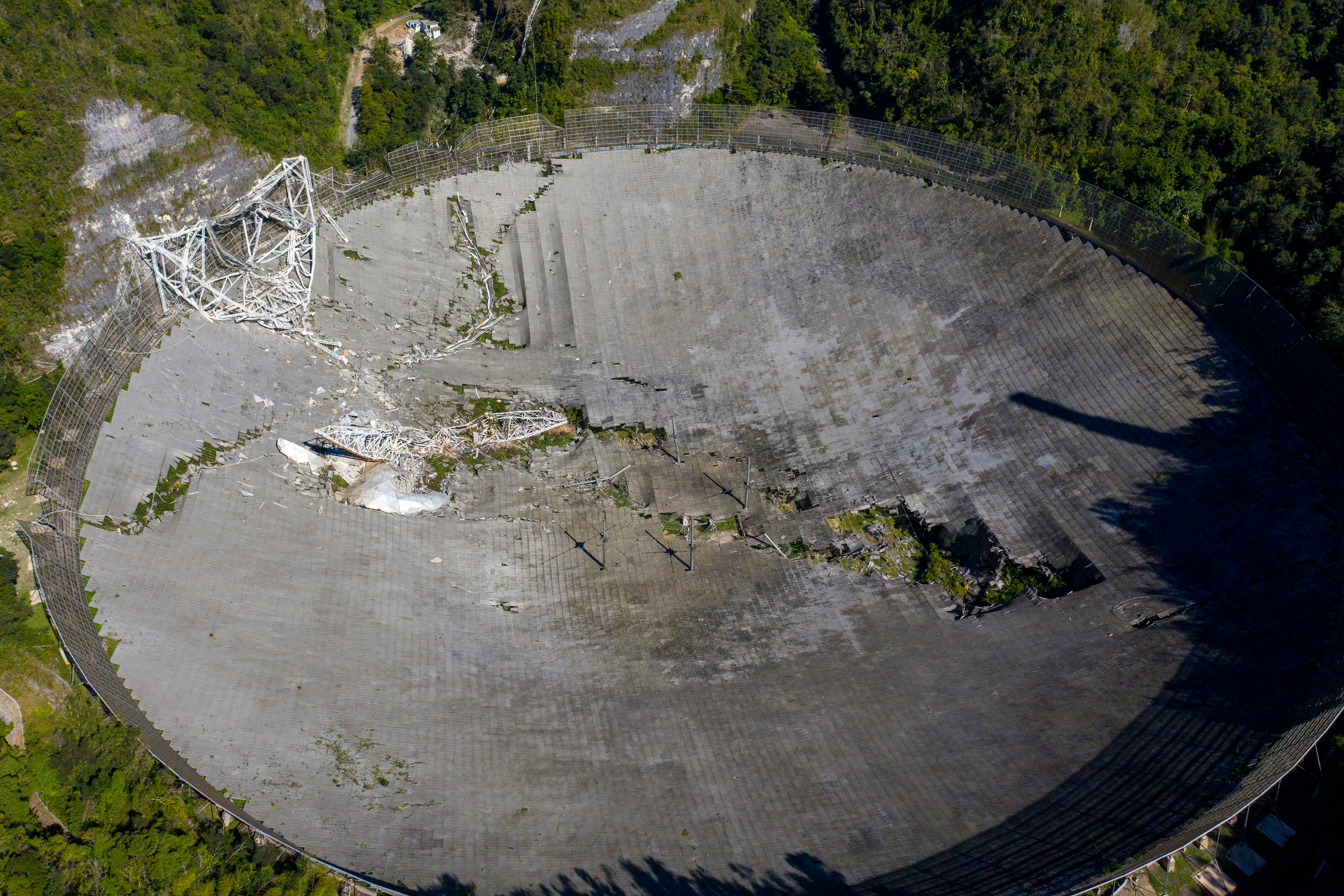 This aerial view shows the damage at the Arecibo Observatory after one of the main cables holding th...