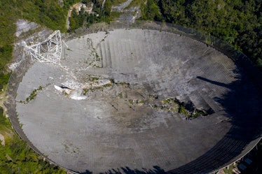 This aerial view shows the damage at the Arecibo Observatory after one of the main cables holding th...