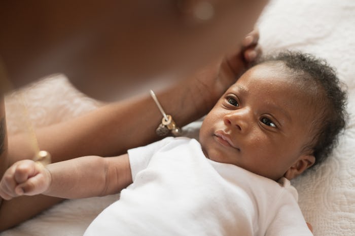 Mom stares lovingly at her newborn her looks back at her, in a story answering the question, why doe...