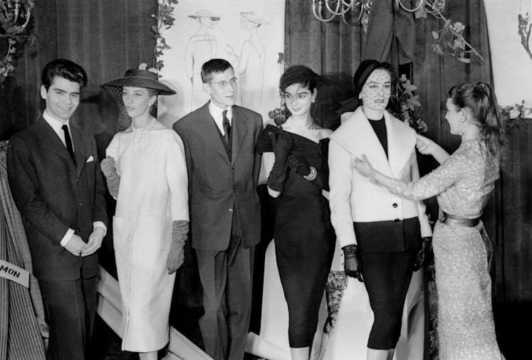 A young Karl Lagerfeld and Yves Saint Laurent with their designs. 