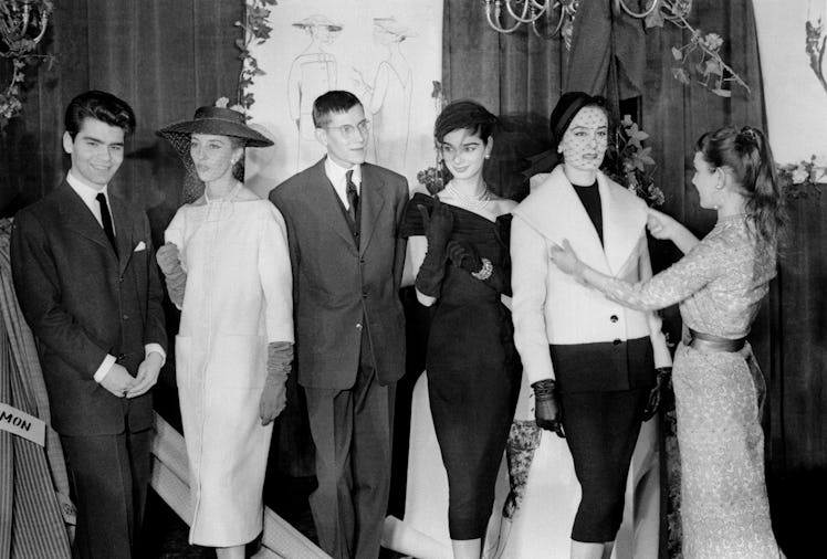 A young Karl Lagerfeld and Yves Saint Laurent with their designs. 