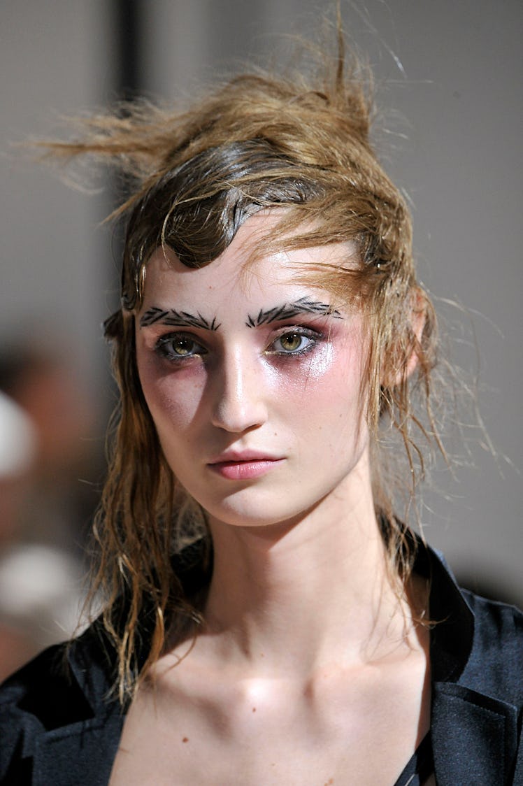 PARIS, FRANCE - SEPTEMBER 26: A model walks the runway during the Yohji Yamamoto Ready to Wear show ...