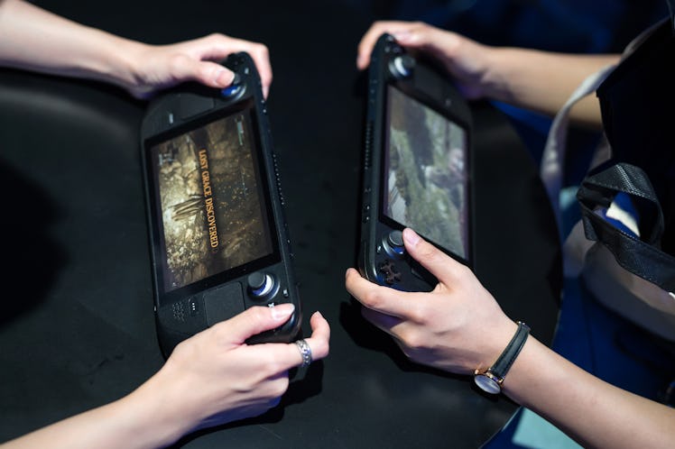 CHIBA, JAPAN - SEPTEMBER 15: Attendees play video games on Steam Deck handheld gaming consoles at th...