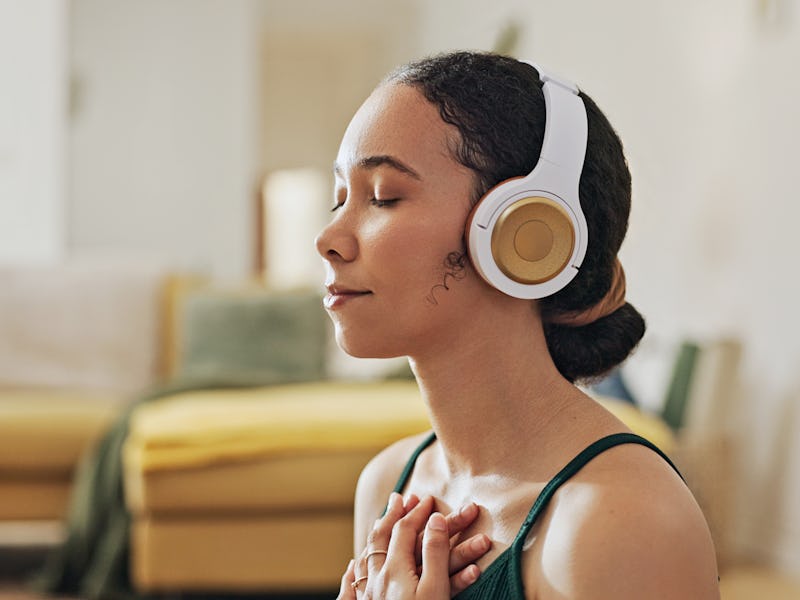 Woman, meditation and yoga in headphones listening to calm music, holistic exercise and peace in liv...