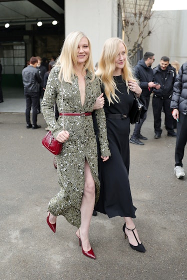  Kirsten Dunst (L) is seen arriving at the Gucci fashion show .
