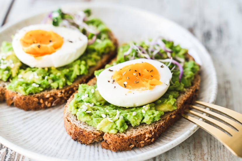 Healthy homemade rustic breakfast Toast With Avocado and Boiled Egg.