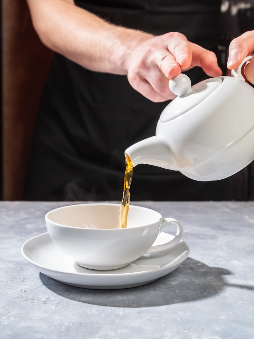 Hot tea in white teapot - English and Chinese tea drinking culture, tea party