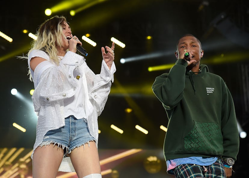 Miley Cyrus performs on stage with Pharrell Williams