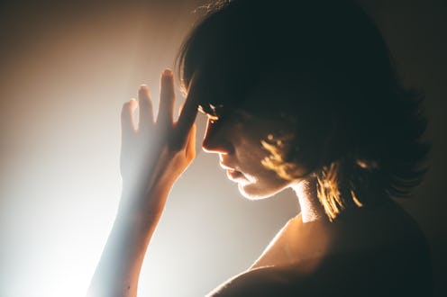 A beautiful Asian young woman, a silhouette dancing in the room with cinematic lights. Symbols of fe...