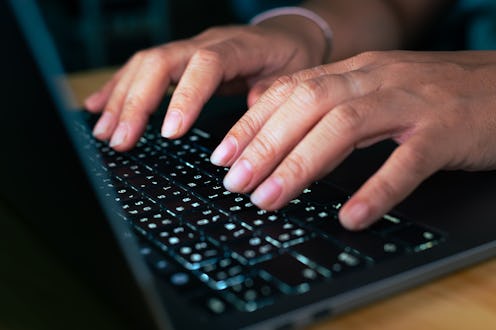 This photo features the hands of a skilled hacker or programmer seamlessly working on a laptop, epit...
