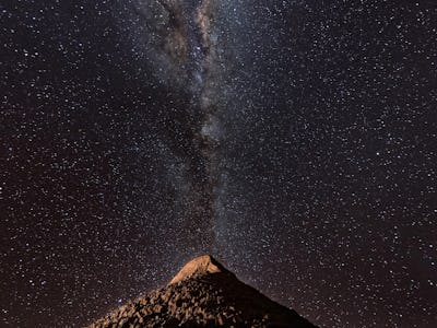 SAN PEDRO DE ATACAMA, CHILE - AUGUST 26: The Milky Way appears over a mountain in the Valle de la Lu...