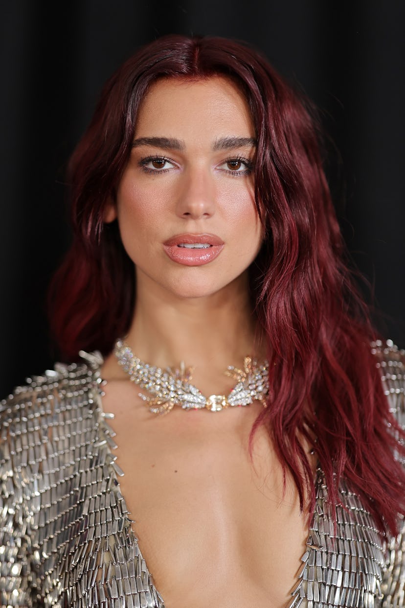 Dua Lipa attends the 66th GRAMMY Awards with tousled mermaid waves.