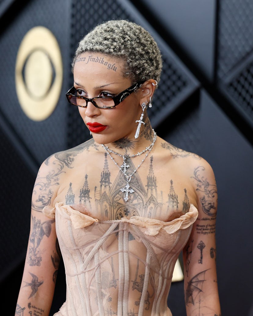 Doja Cat debuted black tattoos at the 2024 GRAMMY Awards in a sheer bustier naked dress
