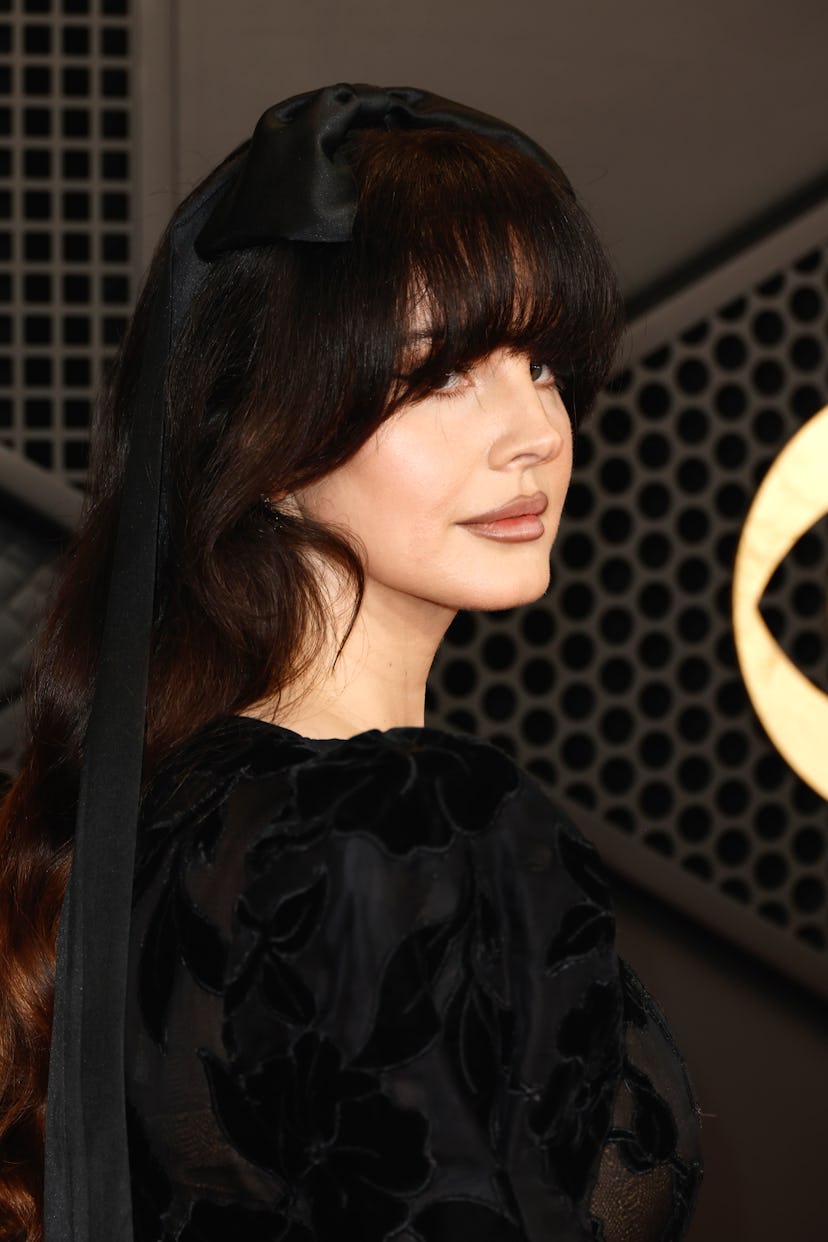 Lana Del Rey attends the 66th GRAMMY Awards with an oversized ribbon in her hair.