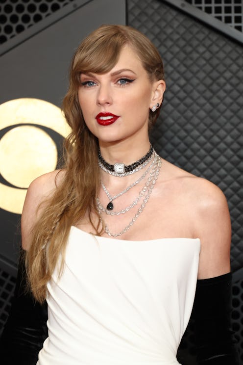Taylor Swift attends the 2024 GRAMMY Awards in a white corset dress and red lips