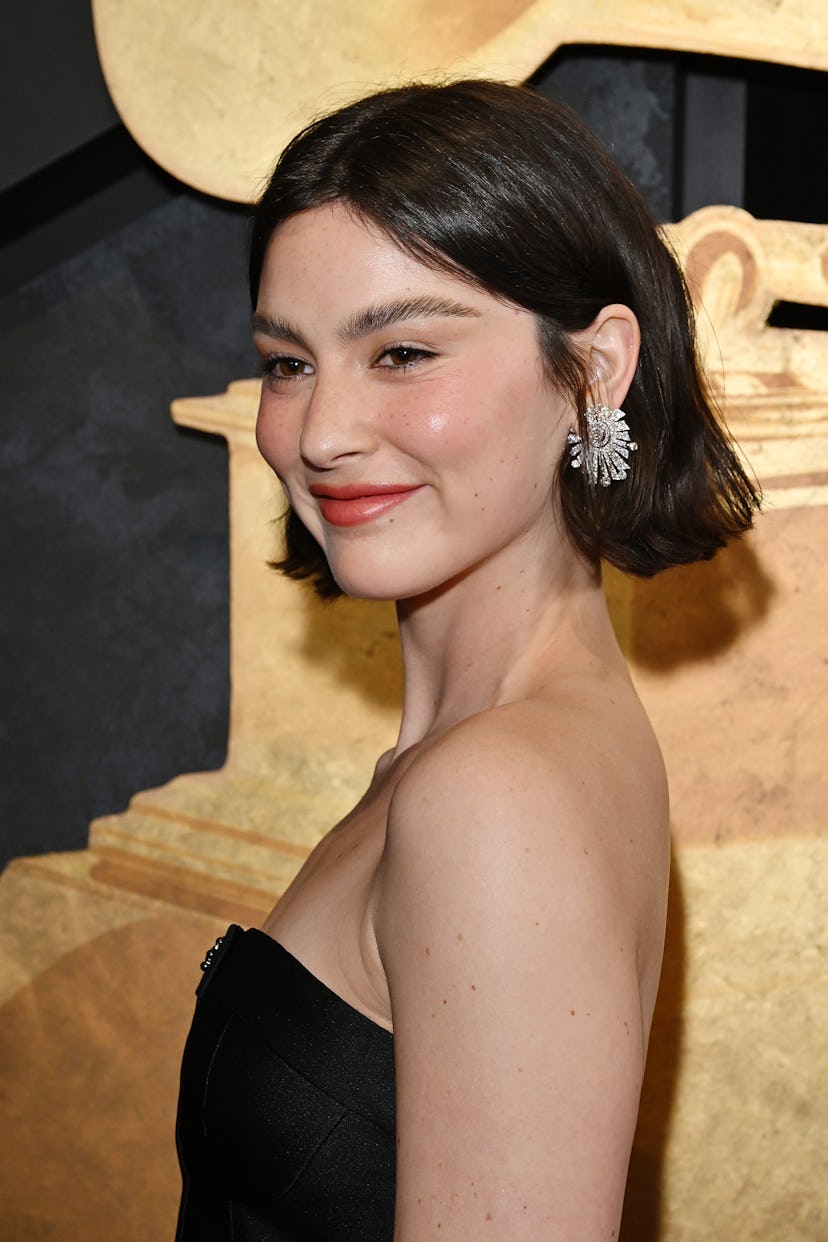 Gracie Abrams attends the 66th GRAMMY Awards with her tousled hair pushed behind her ears.