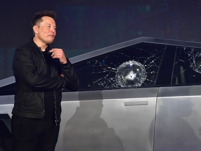 Tesla co-founder and CEO Elon Musk verbally reacts in front of the newly unveiled all-electric batte...