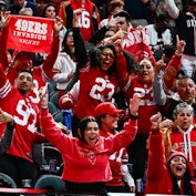 San Francisco 49ers fans cheer during Super Bowl LVIII Opening Night at Allegiant Stadium in Las Veg...