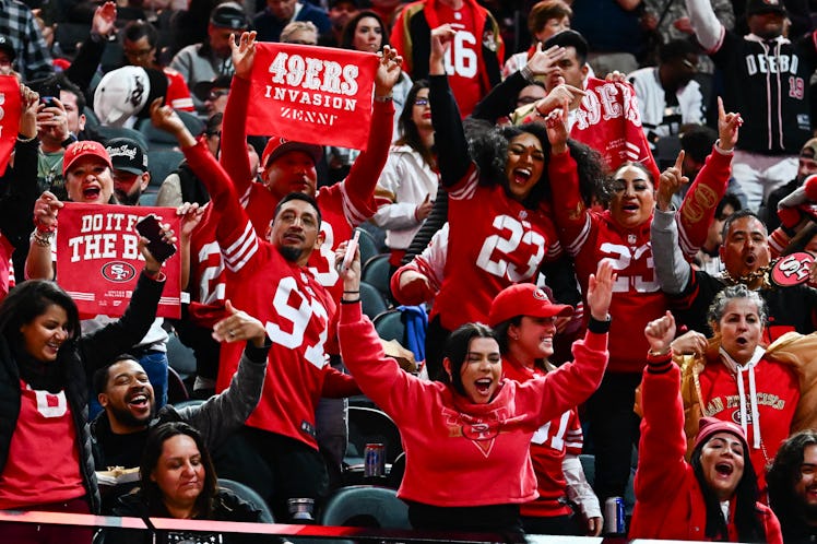 San Francisco 49ers fans cheer during Super Bowl LVIII Opening Night at Allegiant Stadium in Las Veg...