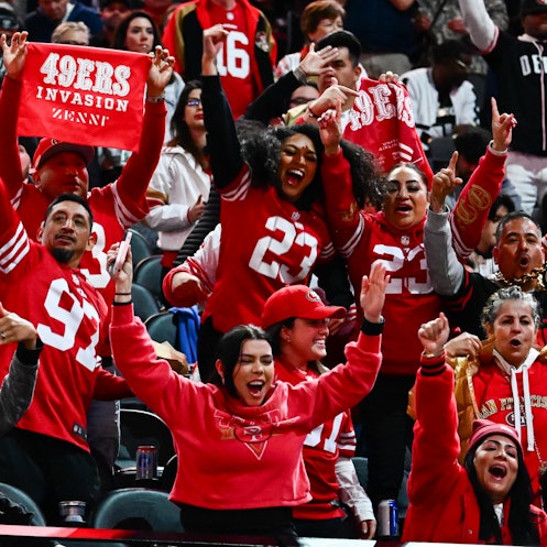 San Francisco 49ers fans cheer during Super Bowl LVIII Opening Night at Allegiant Stadium in Las Veg...