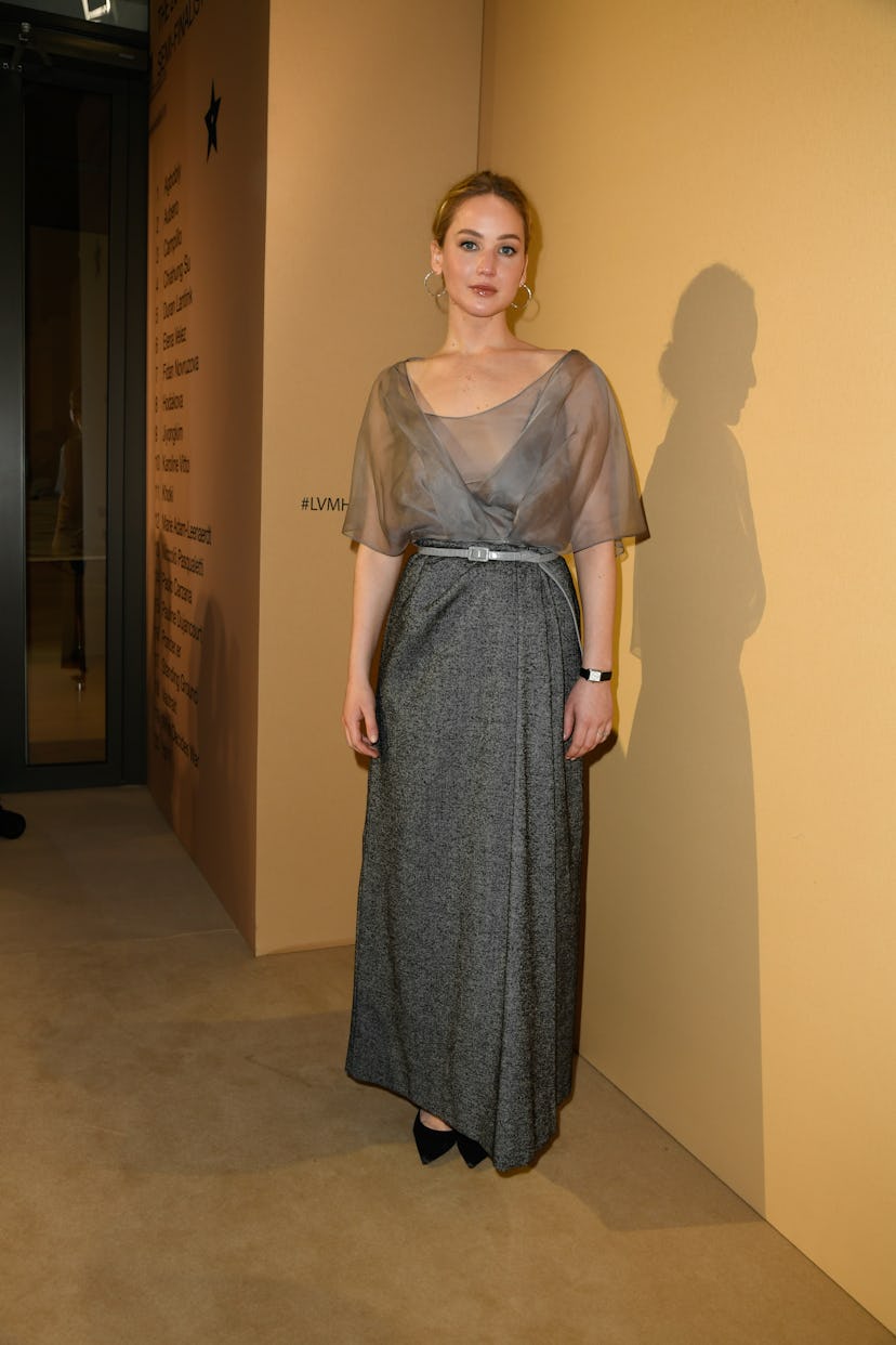 Jennifer Lawrence gray sheer shirt and wool skirt at the LVMH Prize Cocktail Party at Paris Fashion ...