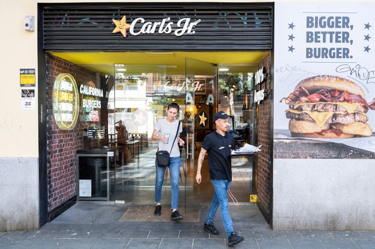 MADRID, SPAIN - 2023/08/16: A customer is seen leaving the American fast food restaurant chain Carl'...