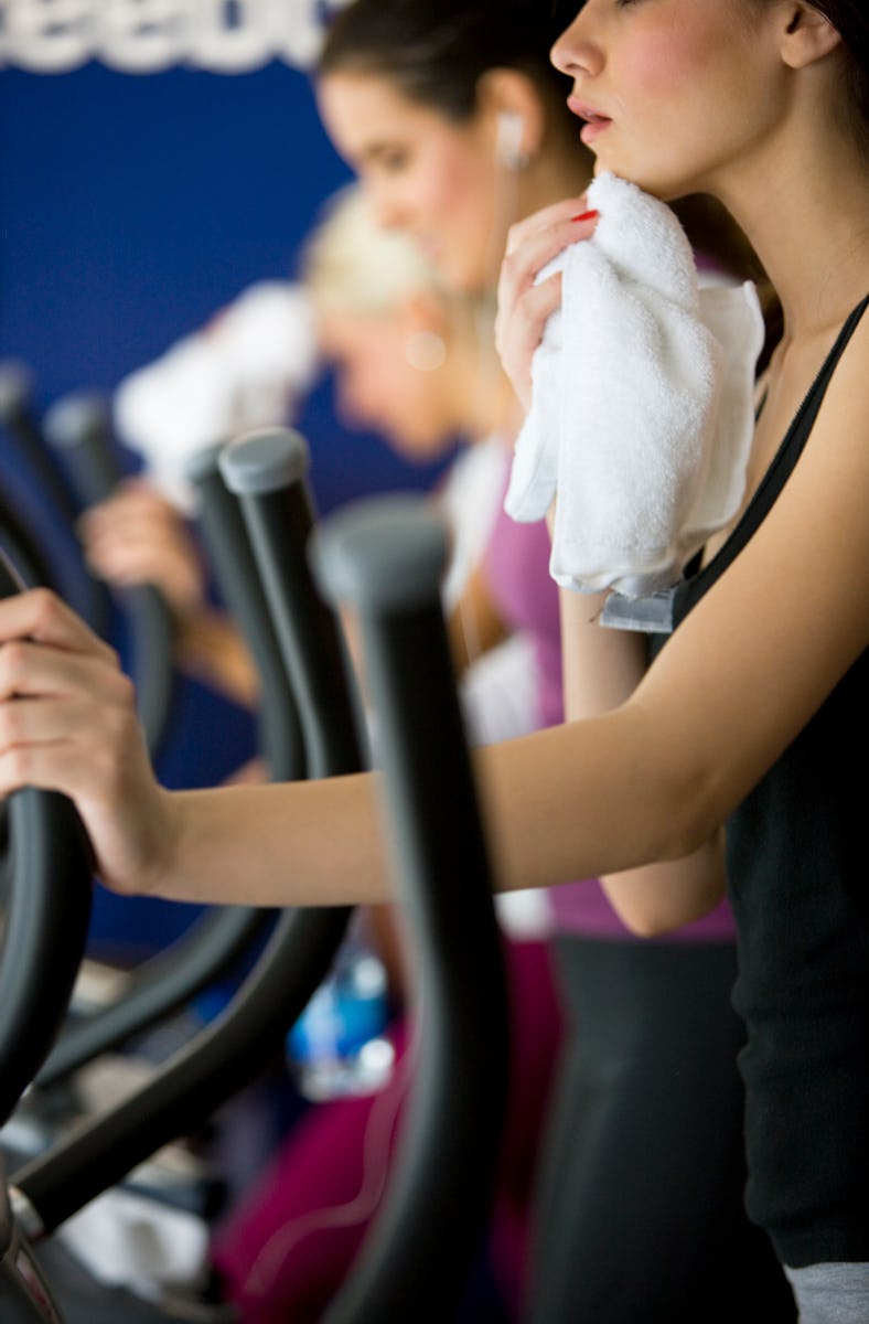 "Woman wiping sweat with towel, canon 1Ds mark III"
