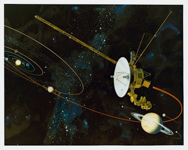 An artist's impression of the Voyager 1 space probe flying past Saturn in the outer solar system, ci...